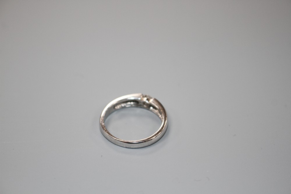 A modern 18ct white gold channel set solitaire diamond ring, size L, gross weight 3.6 grams.